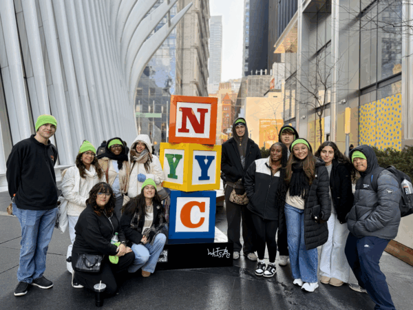 teen advisory board members posing in front of block NYC letters